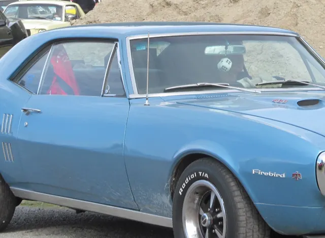1967 Firebird side-trim crop used for fender vent and badge context, not as proof of original 400 equipment.