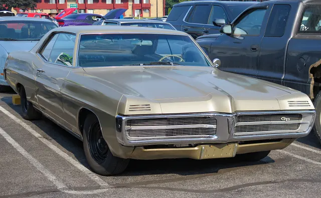 Champagne 1967 Pontiac Grand Prix hardtop in front three-quarter view