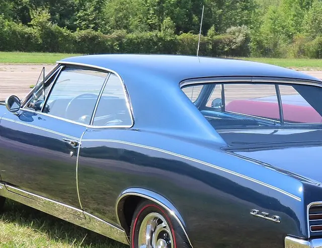 1967 Pontiac GTO rear tail-lamp and trim detail; local crop from approved Commons media for component and trim context only.
