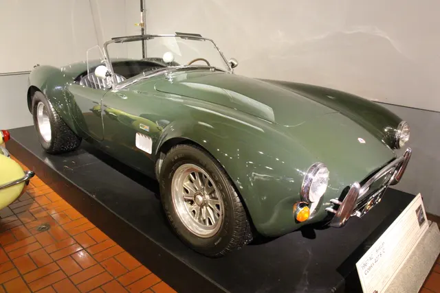 Exact-year S/C display with hood scoop, roll bar, side exhaust, and competition-style wheels. It illustrates documented S/C context and does not represent regular street equipment.
