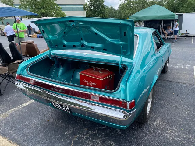 Exact-year base-model rear and open-trunk view retained for tail panel, lamps, bumper, deck, luggage space, and body context; loose accessories and condition are subject-specific.