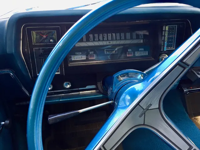 Instrument-panel detail from the same 770 showing the speedometer, clock, warning lamps, fuel and temperature gauges, Shift-Command indicator, steering wheel, and column controls.