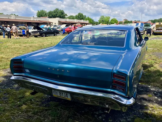 Rear three-quarter view of the same exact-year 770 hardtop retained for the pillarless roof, deck, Rebel script, lamps, bumper, exhaust outlet, and body seams.