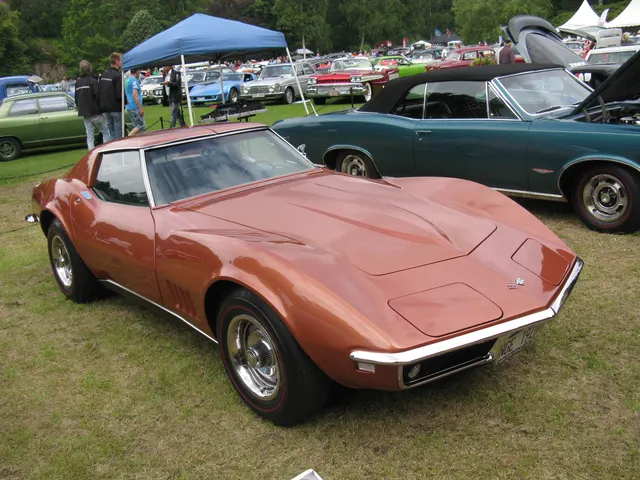 Opposite front view of the Corvette Bronze coupe, documenting its low nose, concealed headlamps, removable roof panels, and model-year wheel treatment.