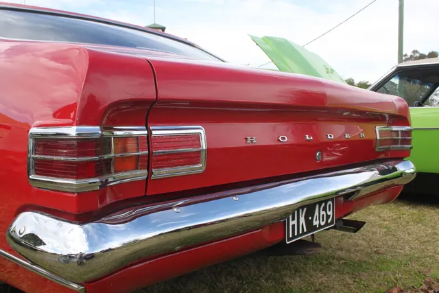 Close view of the regular Monaro's full-width rear-panel treatment, lamps, Holden lettering, bumper, and deck shape.