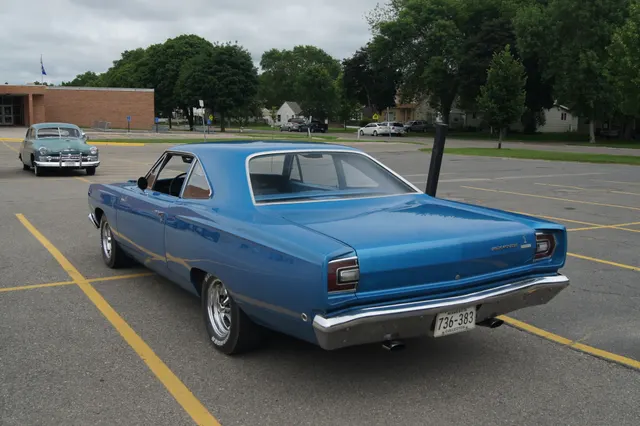 1968 Plymouth Road Runner in a community mobile car-show setting; public history context.