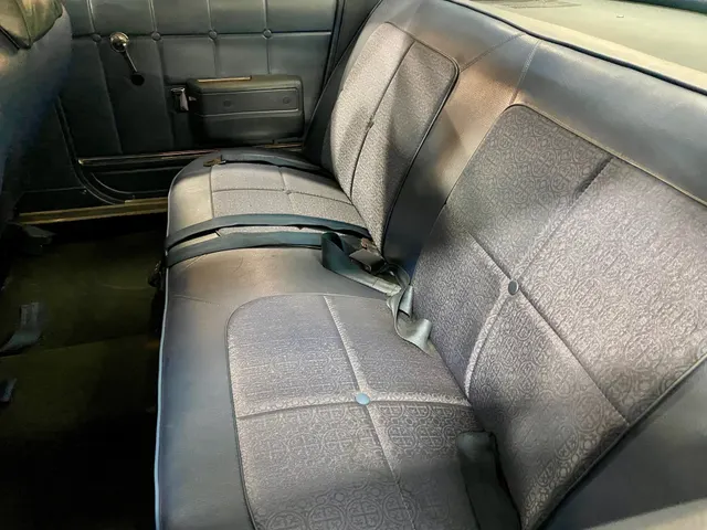 Same-car exact-year Rebel SST rear seating and door-trim view showing the patterned six-passenger upholstery.