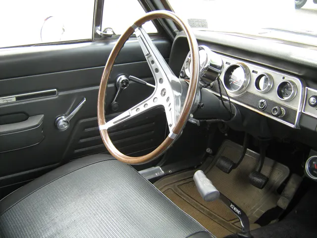 Exact-model SC/Rambler cockpit showing the dashboard, steering wheel, column-mounted Sun tachometer, pedals, door trim, and Hurst shifter; visible service and restoration details do not establish individual-car originality.