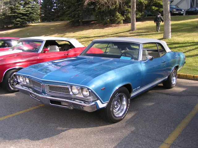 Exact-year SD-396 front three-quarter view retained for the split grille, lamps, hood, fenders, lower SD-396 graphics, bright trim, wheels, tires, vinyl roof, glass, and stance; current finish and restoration details remain car-specific.