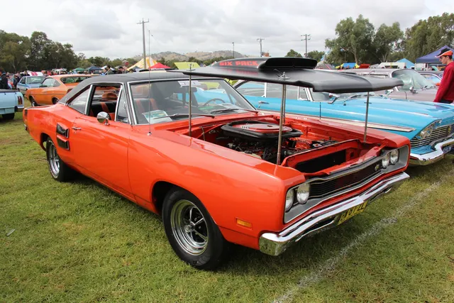 1969 Dodge Super Bee A12 with its lift-off hood displayed; body finish, hood treatment, wheels, and restoration details apply only to the photographed car.