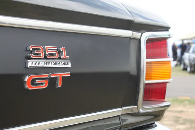 Exact-year XW GT cabin and open-body view documenting seats, dashboard, steering wheel, console, and door trim; restoration materials remain subject-specific.