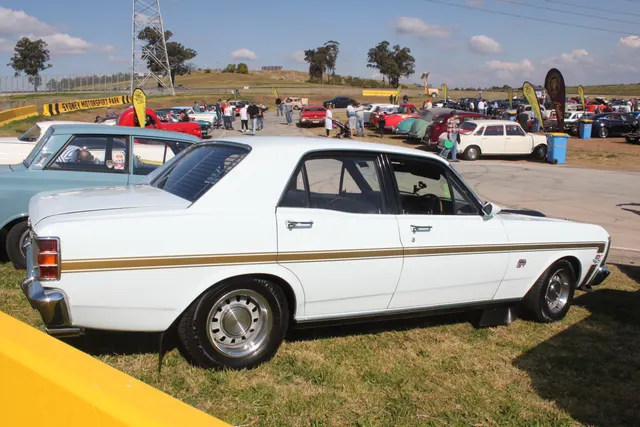 Exact-year regular XW GT front view documenting the black bonnet, scoop, locking pins, grille lamps, bumper, and GT stance.