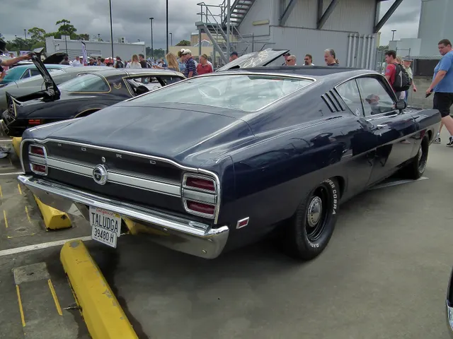 Rear three-quarter view of the same stock-presenting Talladega showing the SportsRoof, black lower deck, stripe, Talladega plaque, lamps, bumper, and road-car stance.