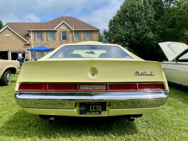 Rear view of the same 1970 Mark Donohue Javelin shown in the primary visual, including the ducktail spoiler, signature, lamps, bumper, and rear body treatment.