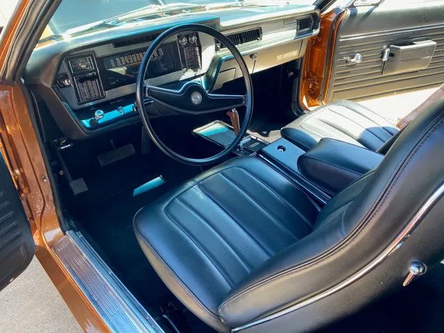 All-original 1970 Rebel Machine cabin with black bucket seats, console, dashboard, and factory automatic pistol-grip shifter; representative interior context without proving another car's options or originality.
