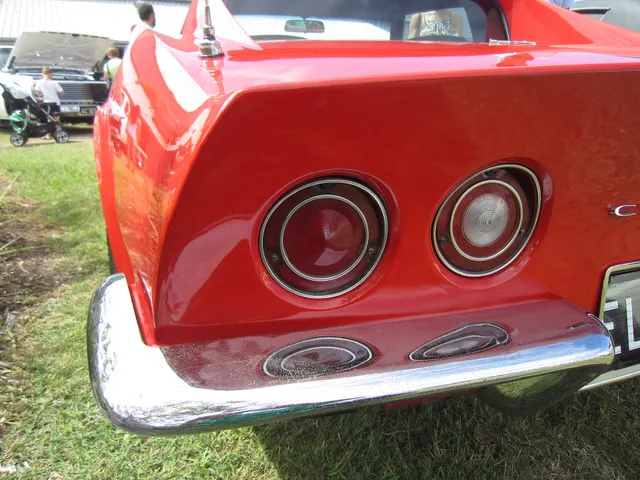 Rear detail of a restored 1970 coupe showing the paired tail lamps, Corvette lettering, bumper treatment, and model-year rectangular exhaust finishers.