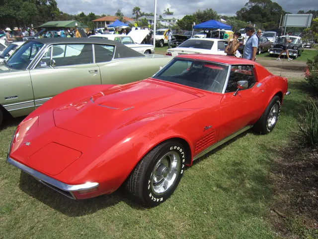 Front three-quarter view of a restored red 1970 Corvette 454 coupe with model-year grille, lamps, hood, and Rally-wheel context.