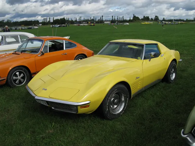 Front three-quarter view of a restored yellow 1970 Corvette coupe showing the low C3 profile, concealed lamps, grille, and wheel-opening flares.