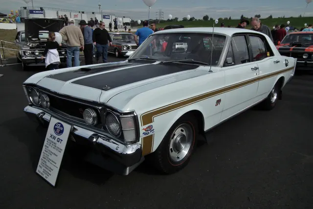 Exact-year regular XW GT rear view showing tail treatment, stripe, identification, roofline, bumper, and slotted wheels.