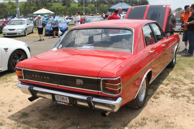 Exact-year regular XW GT side view showing four-door proportions, stripe, trim, badges, and slotted wheels.