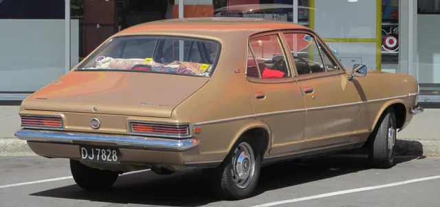 Regular 2600 SL four-door rear three-quarter view documenting the tail, badges, roofline, door arrangement, body trim, and wheel covers.
