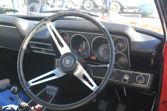 Exact-year XU-1 cabin detail documenting full instruments, sports steering wheel, console, floor-shift controls, and black trim.