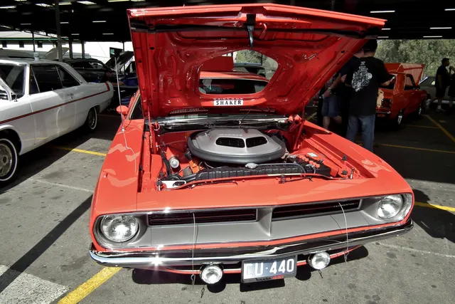 Stock-presenting 440 Six Barrel Cuda engine-bay context; restoration and individual-component originality remain specific to the photographed car