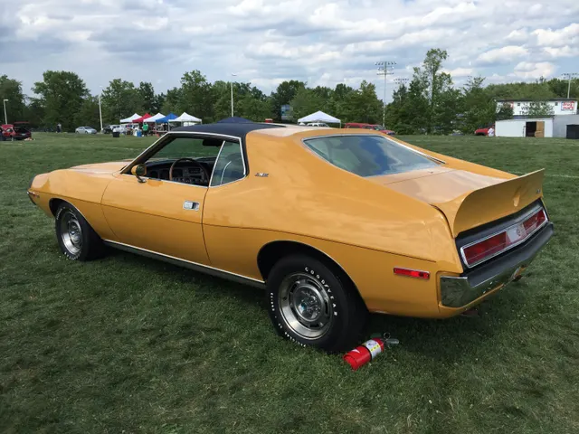 1971 AMC Javelin AMX 401 in Mustard Yellow; exact-model exterior context, not individual-car proof.
