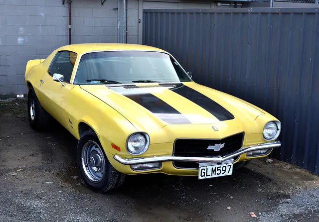 Exact-year Camaro front three-quarter view retained for the split bumper, grille, lamps, hood and stripe treatment, rally wheels, mirrors, glass, and body profile; equipment remains specific to the photographed car.