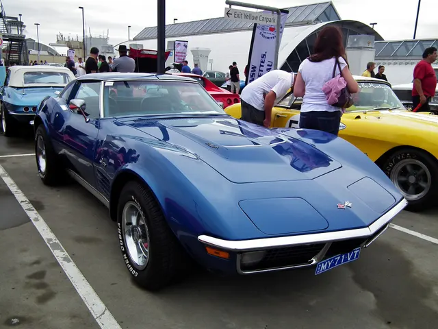 Blue coupe front three-quarter view showing the low C3 profile and removable roof panels; later radial tires are visible.