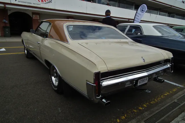 Licensed 1971 Chevrolet Monte Carlo SS coupe rear/right view showing vinyl roof, deck trim and dual exhaust visual context.