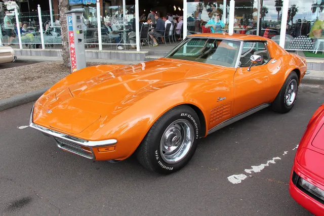 Opposite-side view of an Ontario Orange coupe, retained for roof, body, trim, wheel, and stance context.