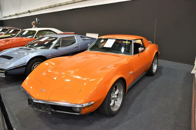 Orange coupe displayed in a museum collection, retained as exact-year historical and design context.