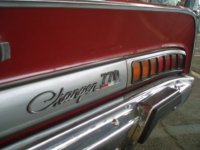 Exact-year E55 tail detail showing Charger 770 identification and lamp treatment; restoration and emblem placement remain specific to the photographed car.