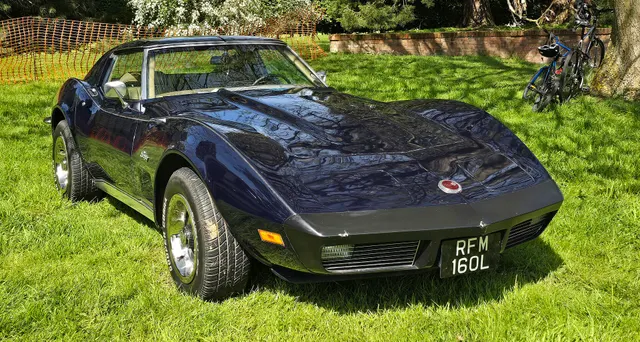 Dark-blue coupe with visible wear on the urethane nose, useful for body-material and restoration inspection context.