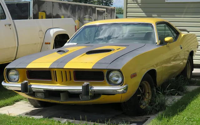 1973 Plymouth Barracuda 340 in Lemon Twist, retained as weathered-car and restoration context rather than a finish-standard example