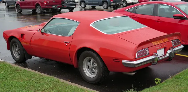 1973 Pontiac Firebird Trans Am rear view in Buccaneer Red; color and spoiler context.