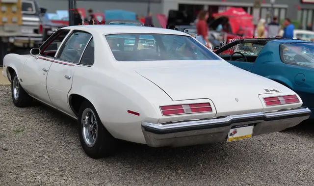 Exact-year view retained for body, trim, glass, lamps, bumpers, and wheel context; condition and restoration details remain specific to the photographed car.