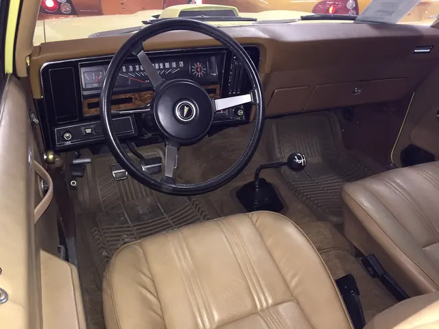 Factory-original-condition GTO-option Ventura cabin showing the dashboard, instruments, steering wheel, controls, manual shifter, seats, door trim, and color combination; equipment remains specific to the photographed car.