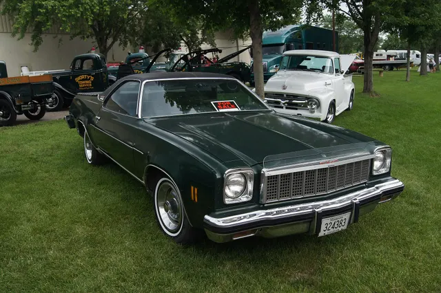 Alternate front three-quarter view of the same exact-year Sprint retained for grille, GMC identification, lamps, bumper, hood, roof, side molding, and wheel-cover context.