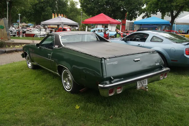 Rear three-quarter view retained for the integrated cargo body, tailgate, lamps, bumper, roof, glass, wheel covers, and preservation context; the removable bed cover, hitch, exhaust, and condition remain car-specific.