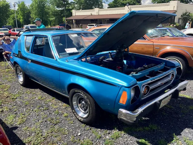 Exact-year Gremlin X with the hood open retained for engine-bay, induction, cooling, brake, firewall, grille, and package context; the visible engine and restoration remain subject-specific.