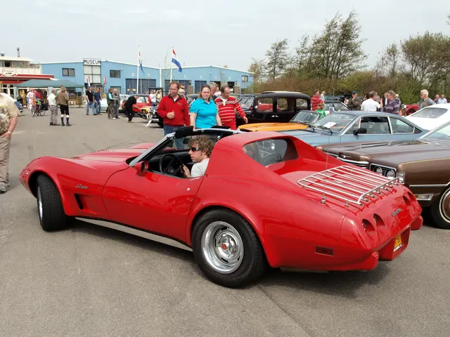 Red 1976 coupe in rear three-quarter view with its roof panels removed, showing the cabin opening, fixed rear glass, luggage rack, urethane tail, and four round lamps.