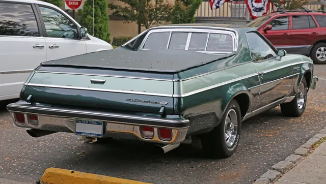Exact-year stock-presenting El Camino Classic showing two-tone paint, bright body moldings, tailgate lettering, lamps, bumpers, tonneau cover, and factory-style wheels; the photographed combination and condition remain car-specific.