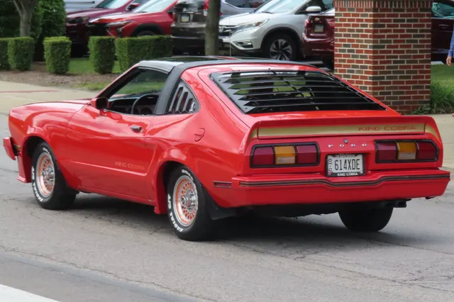 Exact-year King Cobra retained for the rear hatch, spoiler, lamps, bumper, body-side graphics, wheel openings, and stance; rear-window louvers, wheels, condition, and restoration remain specific to this car.
