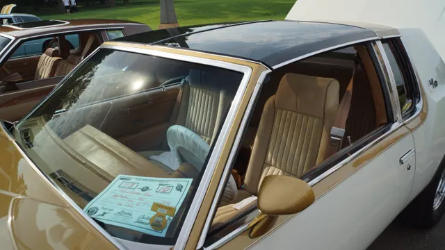Exact-year cabin retained for tan bucket-seat upholstery, rear seating, door trim, belts, dashboard profile, steering wheel, and cabin color; paperwork, reflections, and loose items are not factory equipment.