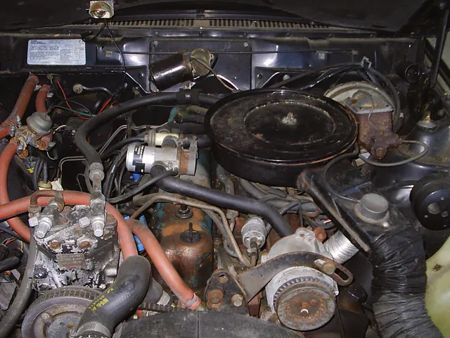 A photographed 1980 Spirit AMX engine bay showing the standard 258-cid straight six, emissions controls, air cleaner, cooling, brake, accessory, hose, wiring, and compartment context; service history, condition, and individual-car originality remain specific to this car.