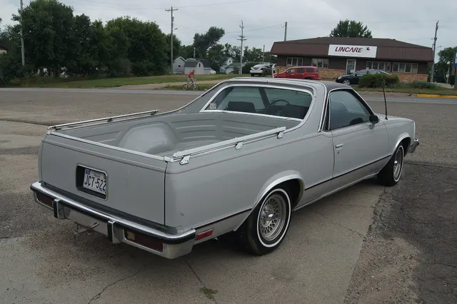 Exact-year rear three-quarter view retained for the double-wall box, tailgate, bed rails, rear glass, lamps, bumper, body moldings, and coupe-utility proportions.