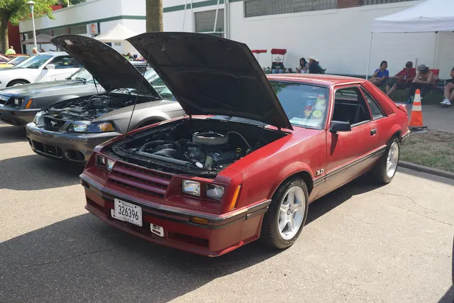 Exact-year 5.0-badged GT retained for hatchback, nose, scoop, body-side, and open-hood context. Its later wheels, tires, open-element induction, engine-bay details, and condition are modified or unresolved and cannot represent factory 5.0 equipment.