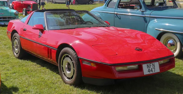 Exact-year front three-quarter view retained for the nose, hood, lamps, windshield angle, removable roof, side vents, belt molding, factory wheel design, and two-seat proportions; finish and condition remain subject-specific.